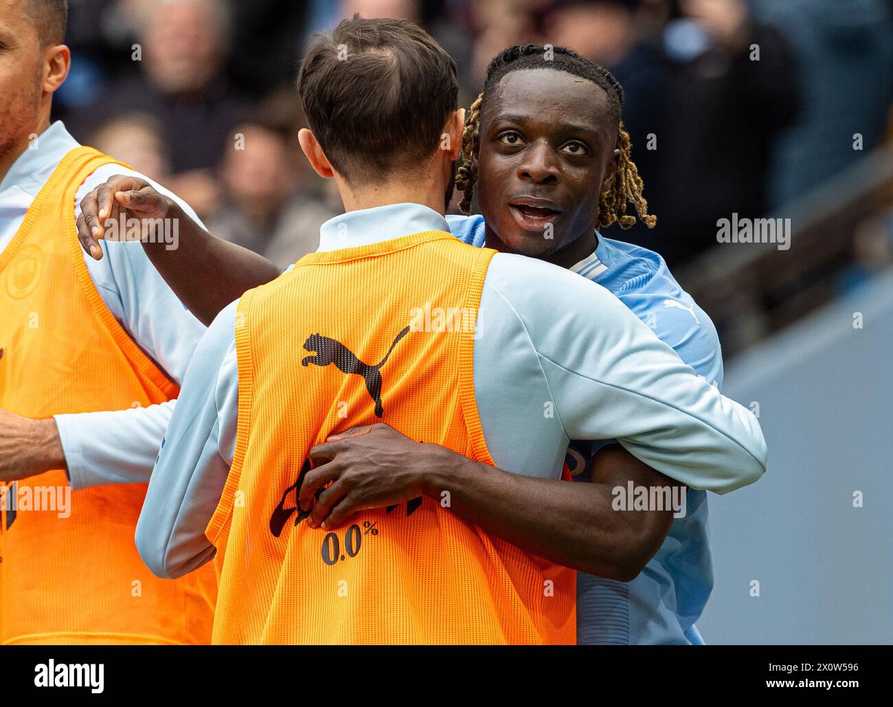 (240414) -- MANCHESTER, April 14, 2024 (Xinhua) -- Manchester City's Jeremy Doku (R) celebrates scoring with teammates during the English Premier League match between Manchester City and Luton Town in Manchester, Britain, April 13, 2024. (Xinhua) FOR EDITORIAL USE ONLY. NOT FOR SALE FOR MARKETING OR ADVERTISING CAMPAIGNS. NO USE WITH UNAUTHORIZED AUDIO, VIDEO, DATA, FIXTURE LISTS, CLUB/LEAGUE LOGOS OR 'LIVE' SERVICES. ONLINE IN-MATCH USE LIMITED TO 45 IMAGES, NO VIDEO EMULATION. NO USE IN BETTING, GAMES OR SINGLE CLUB/LEAGUE/PLAYER PUBLICATIONS. Stock Photo