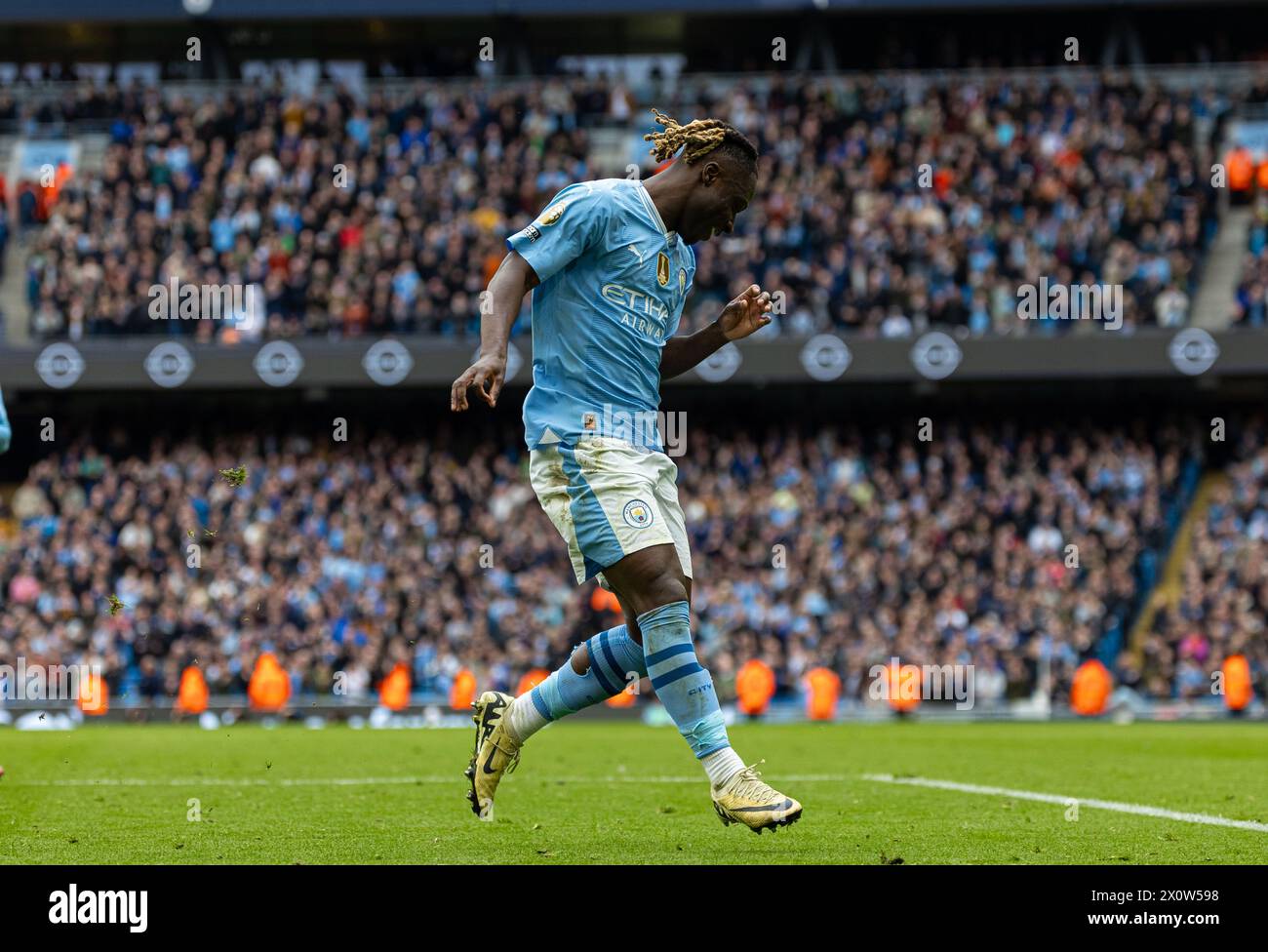 (240414) -- MANCHESTER, April 14, 2024 (Xinhua) -- Manchester City's Jeremy Doku celebrates scoring during the English Premier League match between Manchester City and Luton Town in Manchester, Britain, April 13, 2024. (Xinhua) FOR EDITORIAL USE ONLY. NOT FOR SALE FOR MARKETING OR ADVERTISING CAMPAIGNS. NO USE WITH UNAUTHORIZED AUDIO, VIDEO, DATA, FIXTURE LISTS, CLUB/LEAGUE LOGOS OR 'LIVE' SERVICES. ONLINE IN-MATCH USE LIMITED TO 45 IMAGES, NO VIDEO EMULATION. NO USE IN BETTING, GAMES OR SINGLE CLUB/LEAGUE/PLAYER PUBLICATIONS. Stock Photo