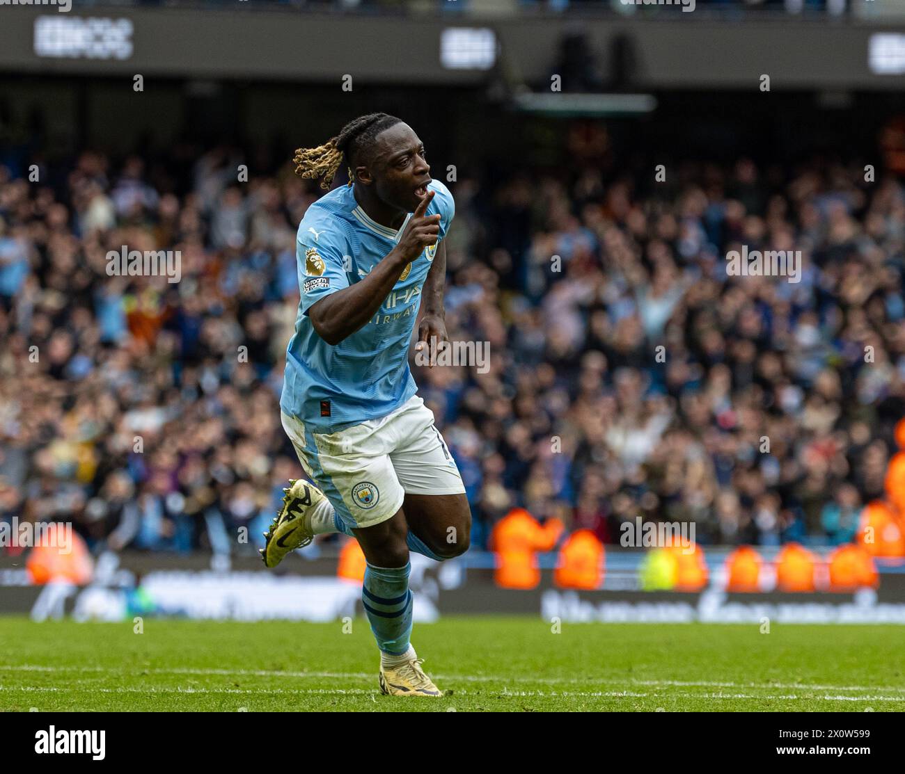 (240414) -- MANCHESTER, April 14, 2024 (Xinhua) -- Manchester City's Jeremy Doku celebrates scoring during the English Premier League match between Manchester City and Luton Town in Manchester, Britain, April 13, 2024. (Xinhua) FOR EDITORIAL USE ONLY. NOT FOR SALE FOR MARKETING OR ADVERTISING CAMPAIGNS. NO USE WITH UNAUTHORIZED AUDIO, VIDEO, DATA, FIXTURE LISTS, CLUB/LEAGUE LOGOS OR 'LIVE' SERVICES. ONLINE IN-MATCH USE LIMITED TO 45 IMAGES, NO VIDEO EMULATION. NO USE IN BETTING, GAMES OR SINGLE CLUB/LEAGUE/PLAYER PUBLICATIONS. Stock Photo