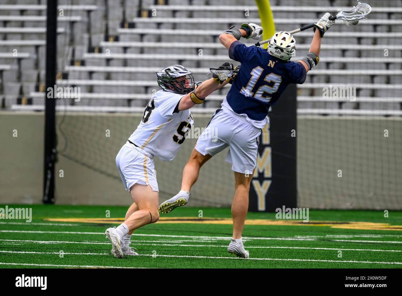 West Point, New York, USA. 13th Apr, 2024. KEAGAN TREACY 98 of the Army Black Knights checks KEEGAN HOUSER 12 of Navy Midshipmen during NCAA Men's Lacrosse action at Michie Stadium (Credit Image: © James Patrick Cooper/ZUMA Press Wire) EDITORIAL USAGE ONLY! Not for Commercial USAGE! Stock Photo