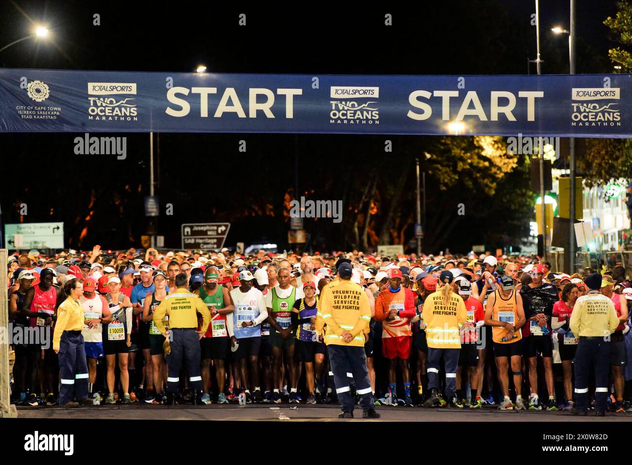 Cape Town, South Africa. 13th Apr, 2024. Participants wait to head out from the starting point in the 2024 Two Oceans Marathon in Cape Town, South Africa, April 13, 2024. The Two Oceans Marathon, which is run against a backdrop of spectacular scenery through the Cape Peninsula, has earned a reputation as 'the world's most beautiful marathon.' Credit: Ian Landsberg/Xinhua/Alamy Live News Stock Photo