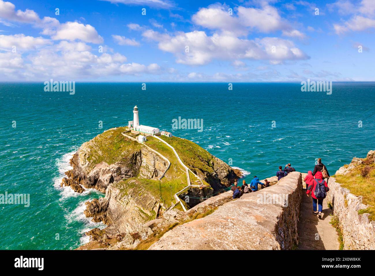 Tourists at South Stack Lighthouse, Anglesey, North Wales. Sky added. Stock Photo