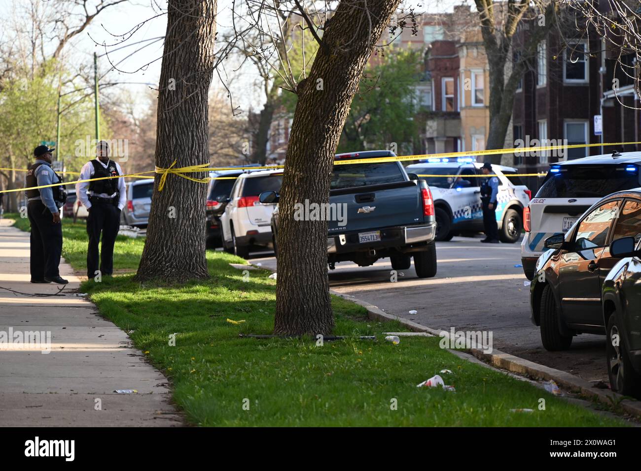 Chicago, United States. 13th Apr, 2024. Police block off roads where the shooting took place. Chicago police officers discovered a 22-year-old male victim lying on the street with multiple gunshot wounds to his body in the 7700 block of S. Carpenter at approximately 5:16 pm, Saturday. The victim was transported to The University of Chicago Hospital where he was pronounced dead. No suspects are in custody. (Photo by Kyle Mazza/SOPA Images/Sipa USA) Credit: Sipa USA/Alamy Live News Stock Photo