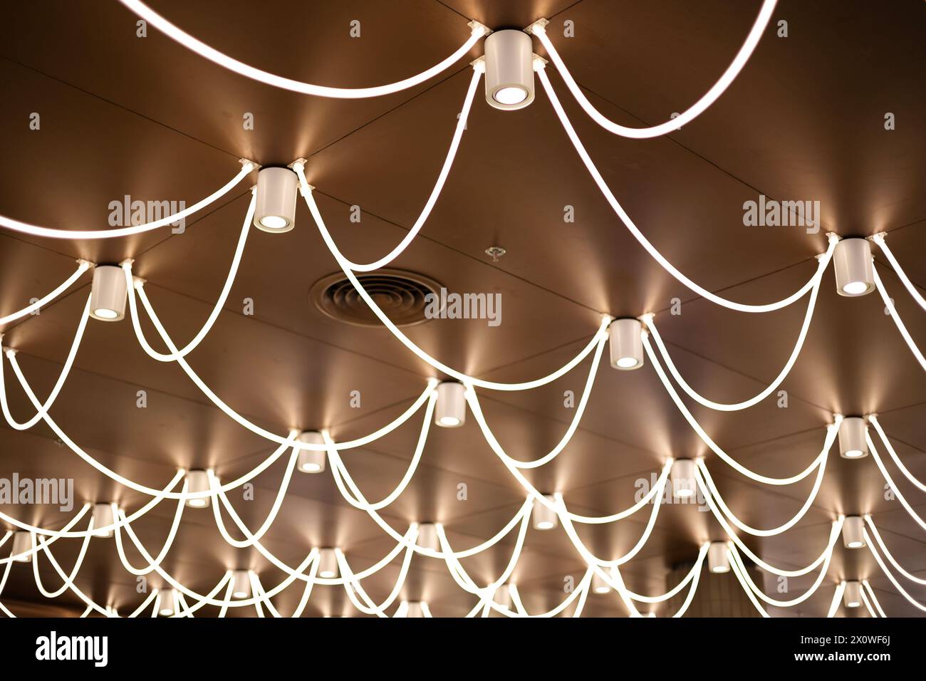 Smoke detector and LED ceiling lights. Ceiling moldings with an intricate crown in the inner corner. Stock Photo