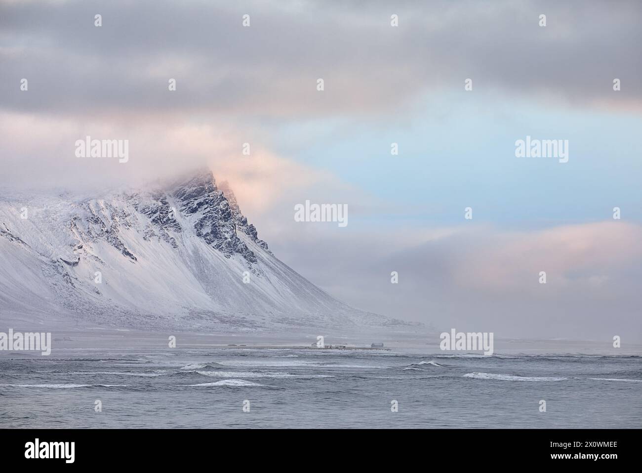 Winter sunrise over snow covered volcanic peaks, Iceland Stock Photo
