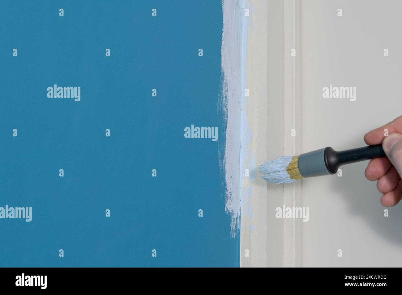 Painting areas where walls meet door jambs using masked adhesive tape