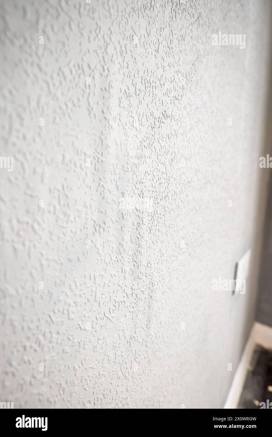 grey painted woodchip wallpaper texture pattern backgroung. Stock Photo