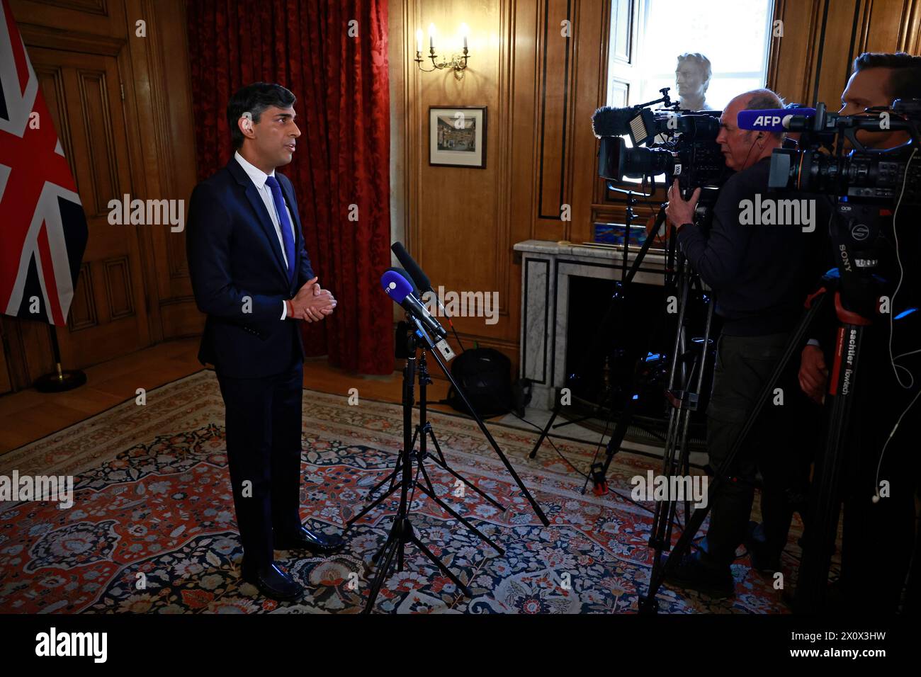 Prime Minister Rishi Sunak records a statement inside 10 Downing Street, London, after Iran launched an unprecedented attack on Israel that saw RAF jets deployed to shoot down drones from Tehran. Mr Sunak said 'the fallout for regional stability would be hard to overstate' had Iran's attack on Israel been successful, as he confirmed RAF pilots shot down 'a number' of attack drones. Picture date: Sunday April 14, 2024. Stock Photo