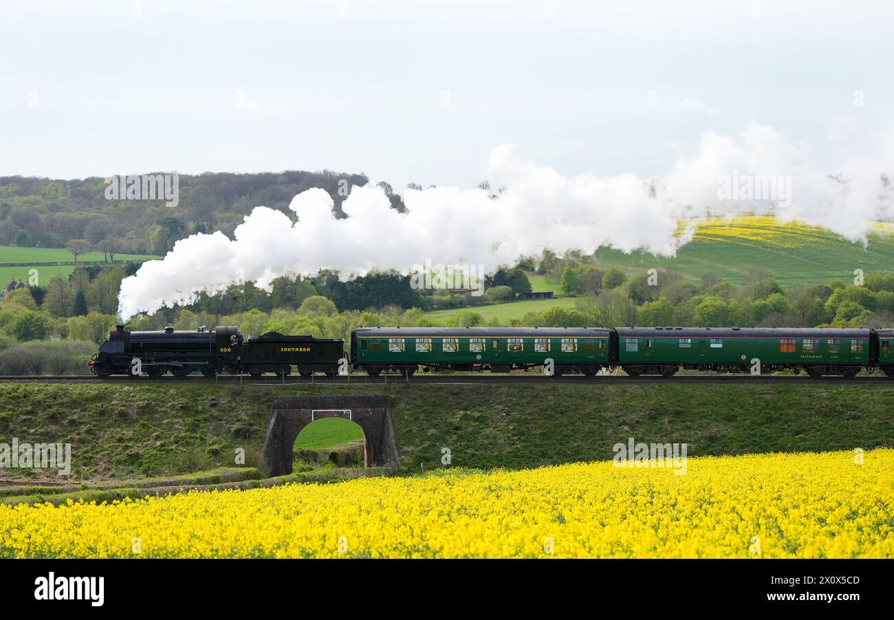 The S15 class steam locomotive 506 travels along the Mid Hants Railway, also known as the Watercress line, near to Ropley in Hampshire. Picture date: Sunday April 14, 2024. Stock Photo
