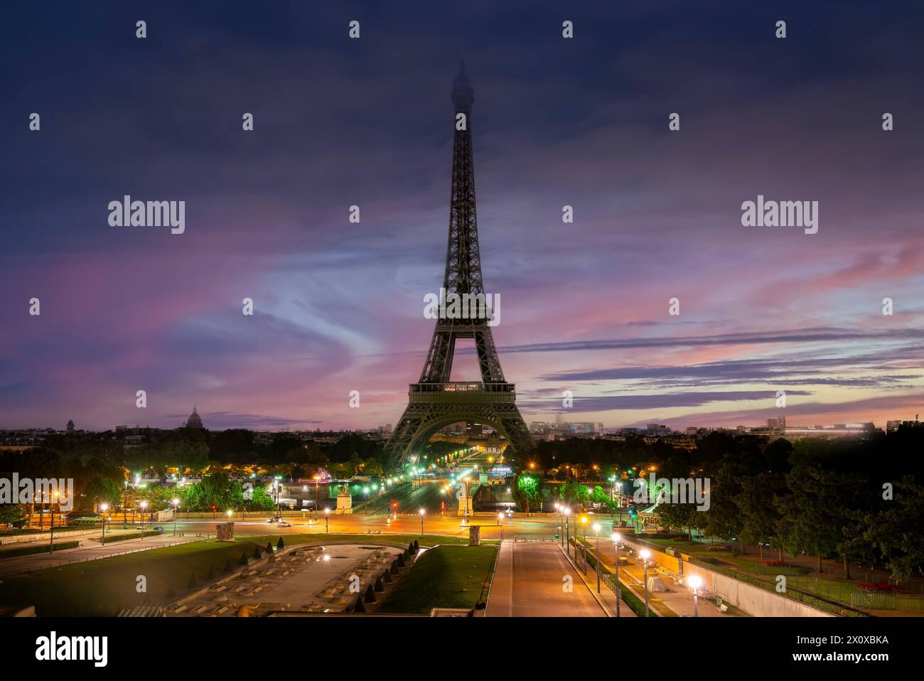 Eiffel Tower and fountains near it at dawn in Paris, France Stock Photo