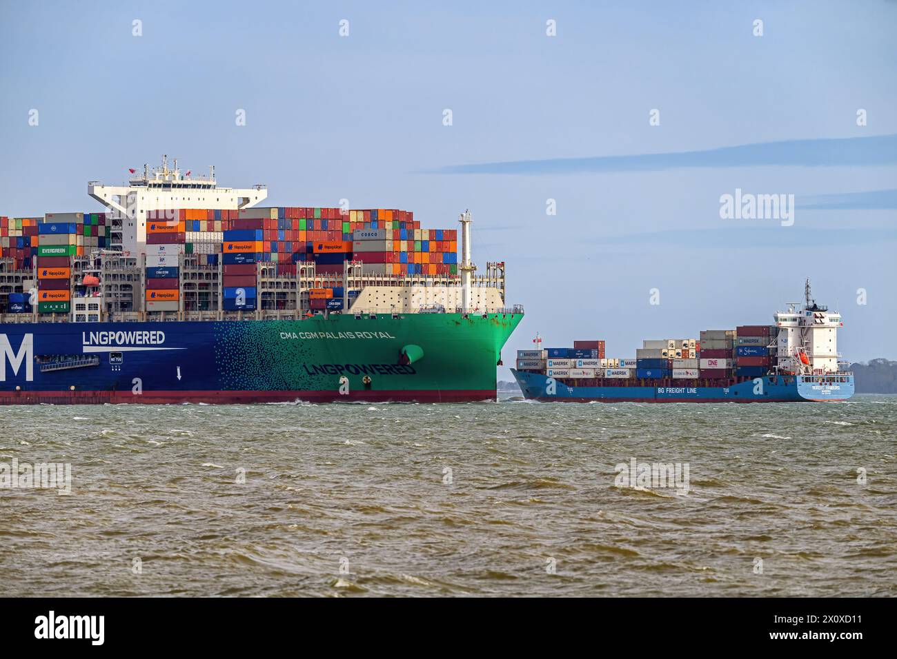 An Ultra Large container carrier passing a smaller feeder container ...