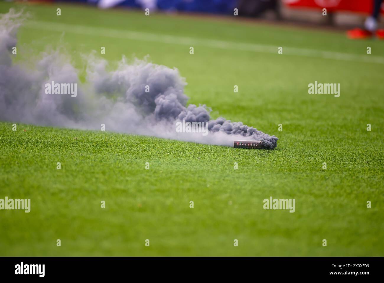 Fredrikstad, Norway, 13nd April 2024.  Smoke bomb on the pitch in the Eliteserien match between Fredrikstad and Sarpsborg 08 at Fredrikstad stadium.  Credit: Frode Arnesen/Alamy Live News Stock Photo