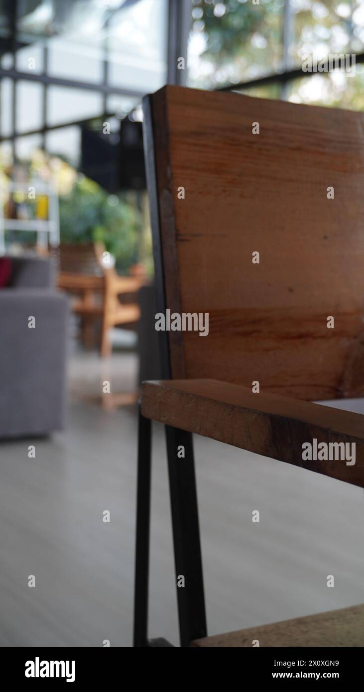 Custom brown wooden chairs with black iron with an industrial concept in a cafe with a blurred background Stock Photo