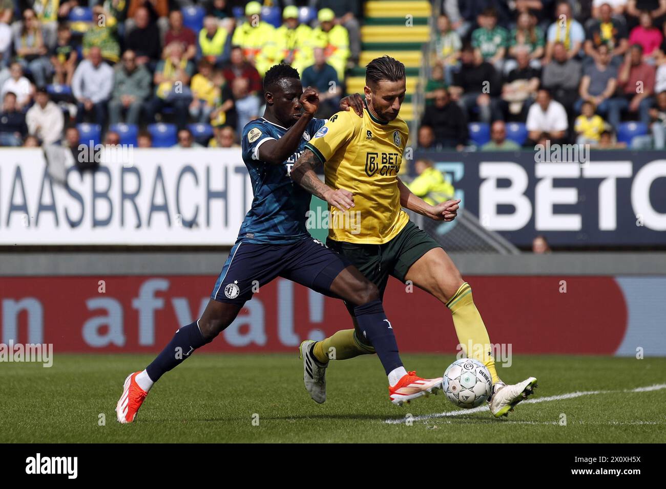 SITTARD - (l-r) Yankuba Minteh of Feyenoord, Mitchell Dijks of Fortuna Sittard during the Dutch Eredivisie match between Fortuna Sittard and Feyenoord Rotterdam at the Fortuna Sittard Stadium on April 14, 2024 in Sittard, Netherlands. ANP BART STOUTJESDIJK Stock Photo