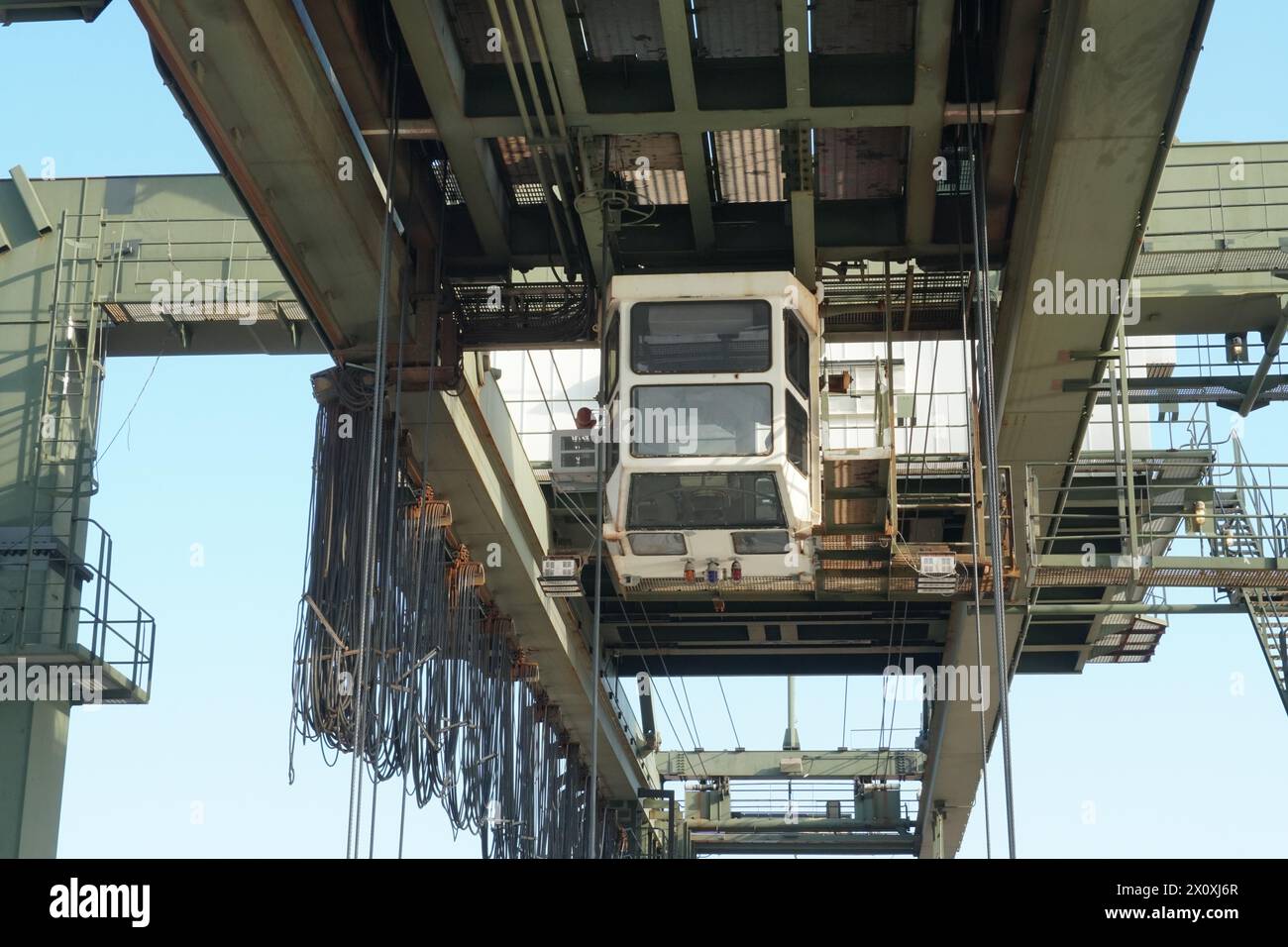 White cabin of green gantry crane operated by stevedores in Houston
