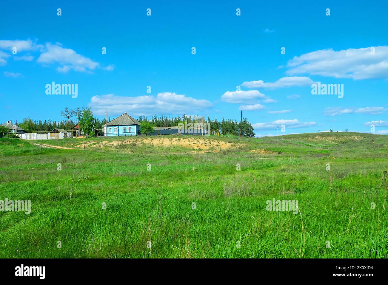 A house on overgrown with steppe vegetation dunes in the valley of the Don River, temperate grassland, fescue-forb steppe. southern Russia Stock Photo