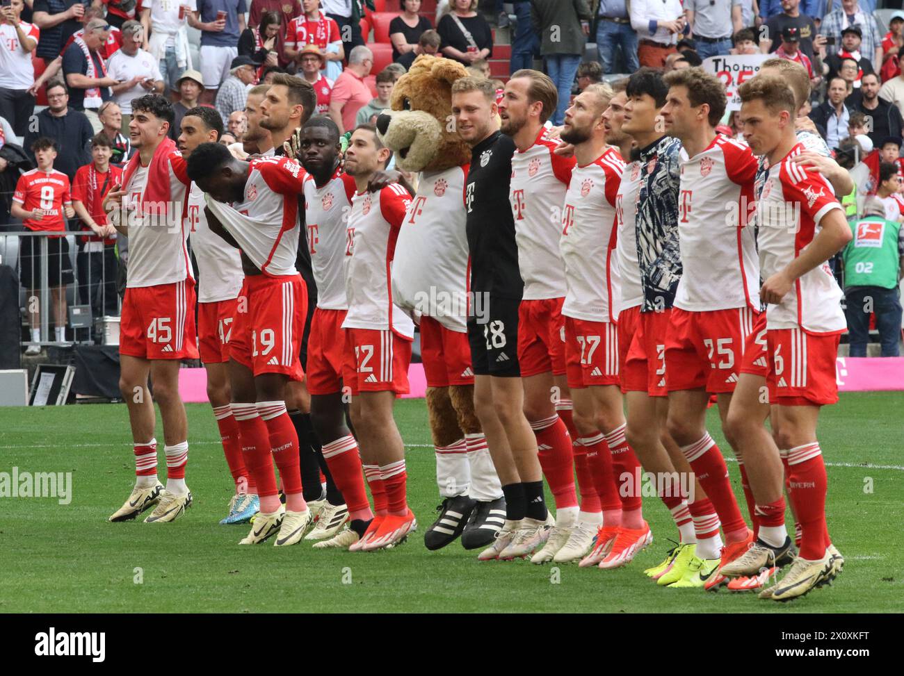 MUNICH, Germany - 13. April 2024: Die Bayern - Spieler feiern mit den Fans den Sieg vor der Suedkurve, Celebration of fans with the players Aleksandar Pavlovic (FC Bayern Muenchen), Jamal Musiala (FC Bayern Muenchen), Eric Dier (FC Bayern Munechen), Sven Ulreich (FC Bayern Muenchen), Alphons Davies (FC Bayern Muenchen), Dayot Upamecano (FC Bayern Muenchen), Raphael Guerreiro (FC Bayern Muenchen), #Berni, Daniel Peretz (FC Bayern Muenchen), Harry Kane (FC Bayern Muenchen), Konrad Laimer (FC Bayern Muenchen), Leon Goretzka (FC Bayern Muenchen), Noussair Mazraoui during the Bundesliga Football m Stock Photo