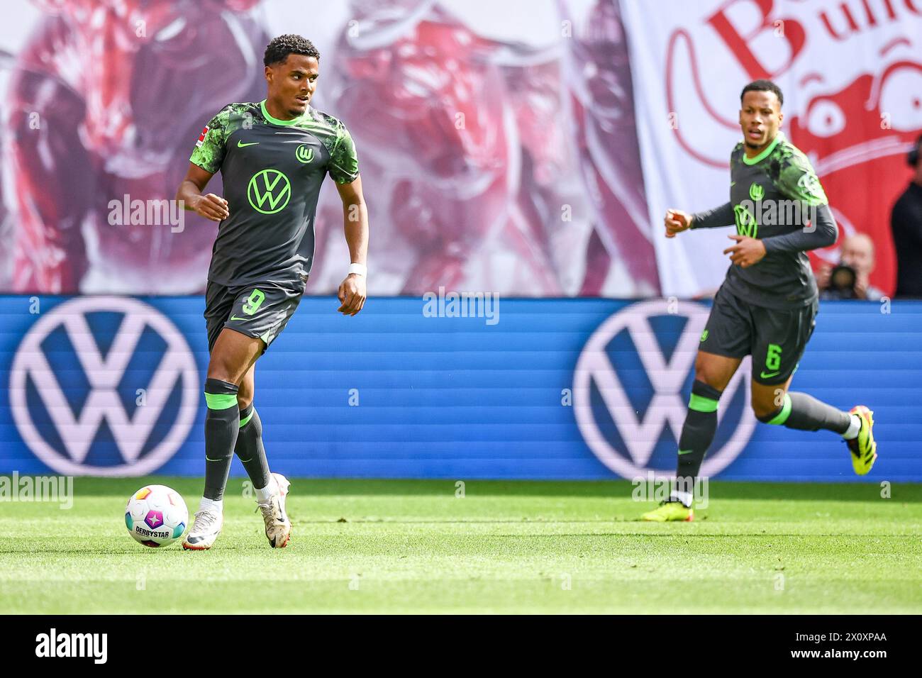 Leipzig, Germany. 13th Apr, 2024. Soccer: Bundesliga, RB Leipzig - VfL Wolfsburg, matchday 29 at the Red Bull Arena. Wolfsburg players (l) Amin Sarr and Aster Vranckx on the ball. Credit: Jan Woitas/dpa - IMPORTANT NOTE: In accordance with the regulations of the DFL German Football League and the DFB German Football Association, it is prohibited to utilize or have utilized photographs taken in the stadium and/or of the match in the form of sequential images and/or video-like photo series./dpa/Alamy Live News Stock Photo