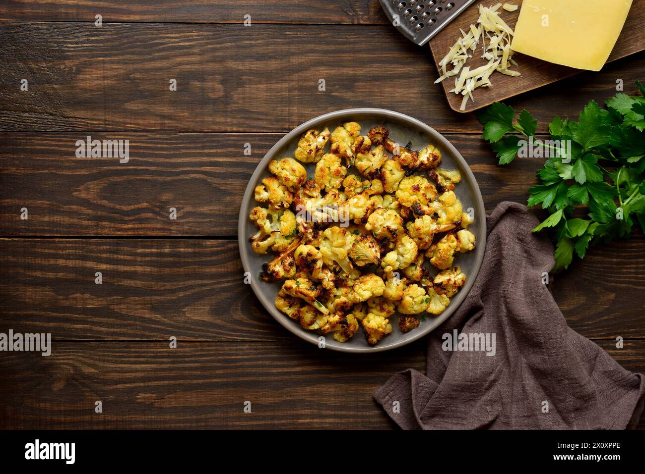 Roasted cauliflower on wooden background with free space. Top view, flat lay Stock Photo