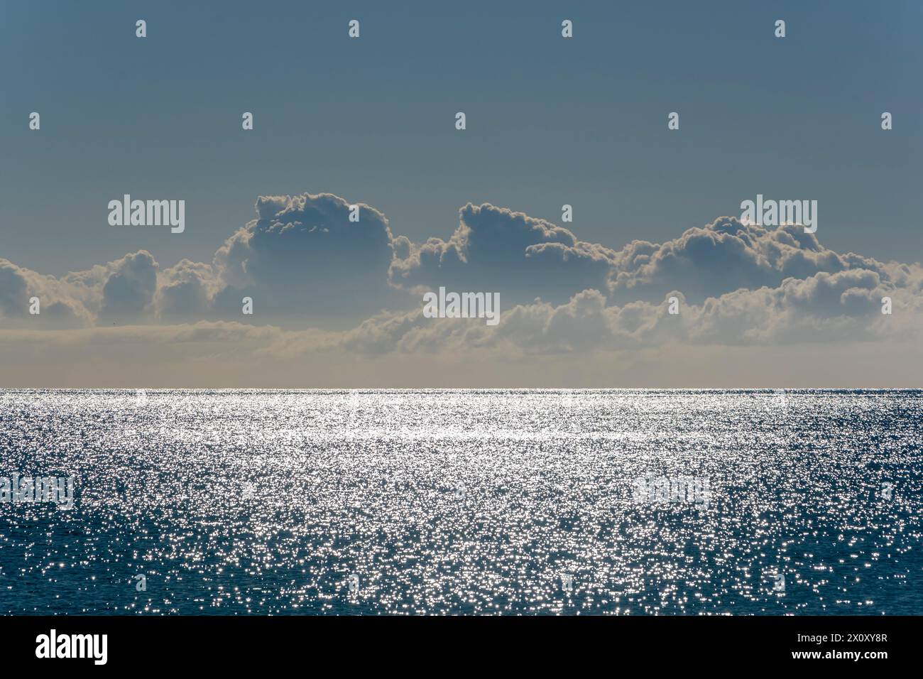 Beautiful seascape, evening clouds, reflections on the water from the setting sun. Stock Photo