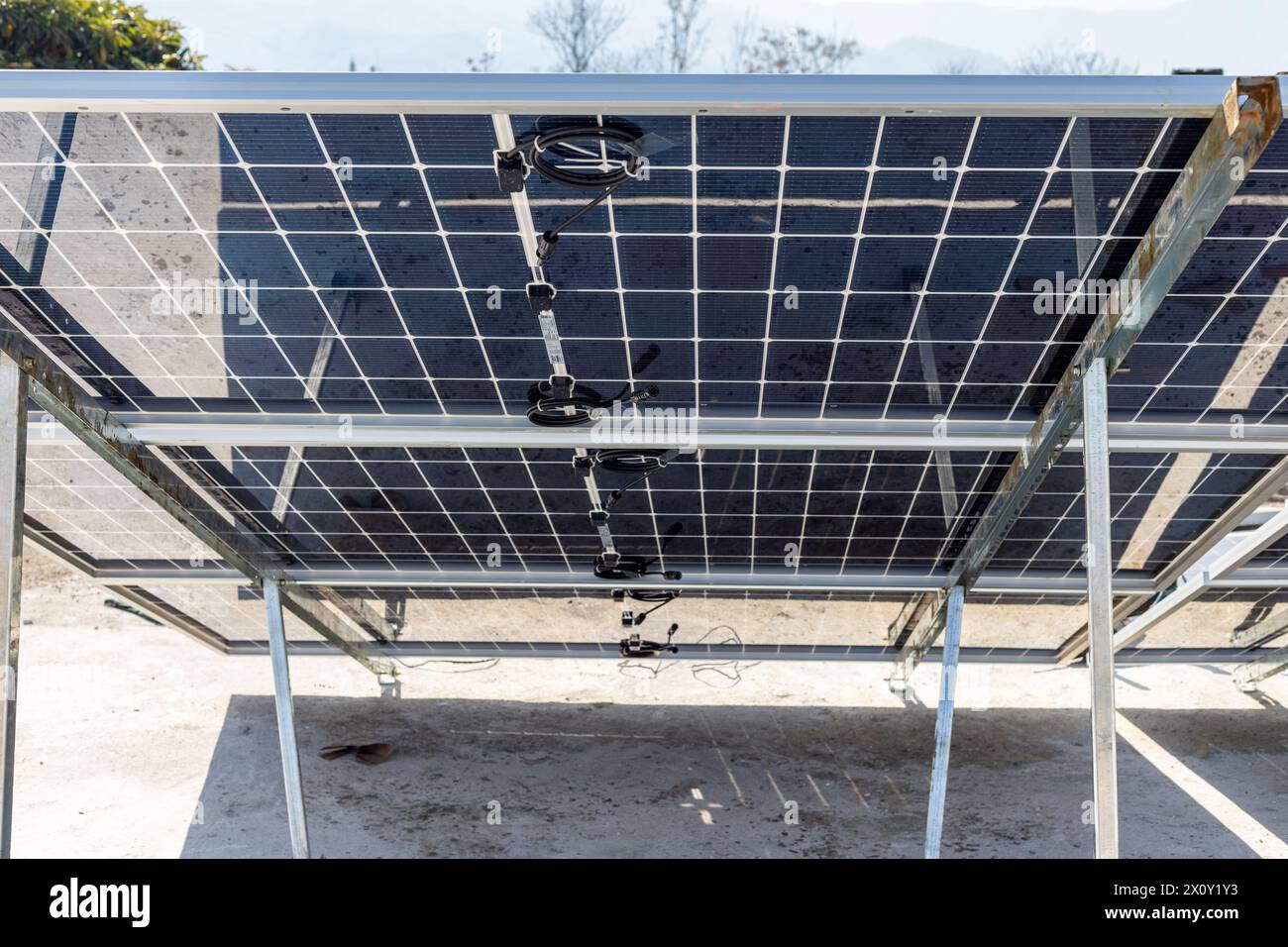 Rear view of a solar panels on metal stand on the roof of a house for generating clean electricity Stock Photo