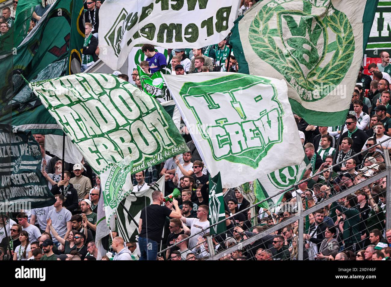 LEVERKUSEN - Werder Bremen fans during the Bundesliga match between Bayer 04 Leverkusen and Werder Bremen at the Bay Arena on April 14, 2024 in Leverkusen, Germany. ANP | Hollandse Hoogte | GERRIT VAN COLOGNE Stock Photo