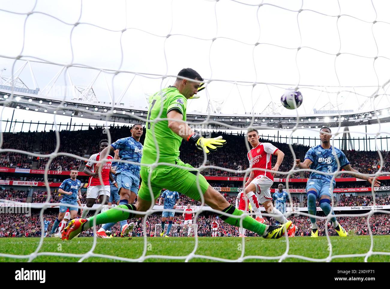 Aston Villa goalkeeper Emiliano Martinez saves a shot from Arsenal's Leandro Trossard during the Premier League match at the Emirates Stadium, London. Picture date: Sunday April 14, 2024. Stock Photo