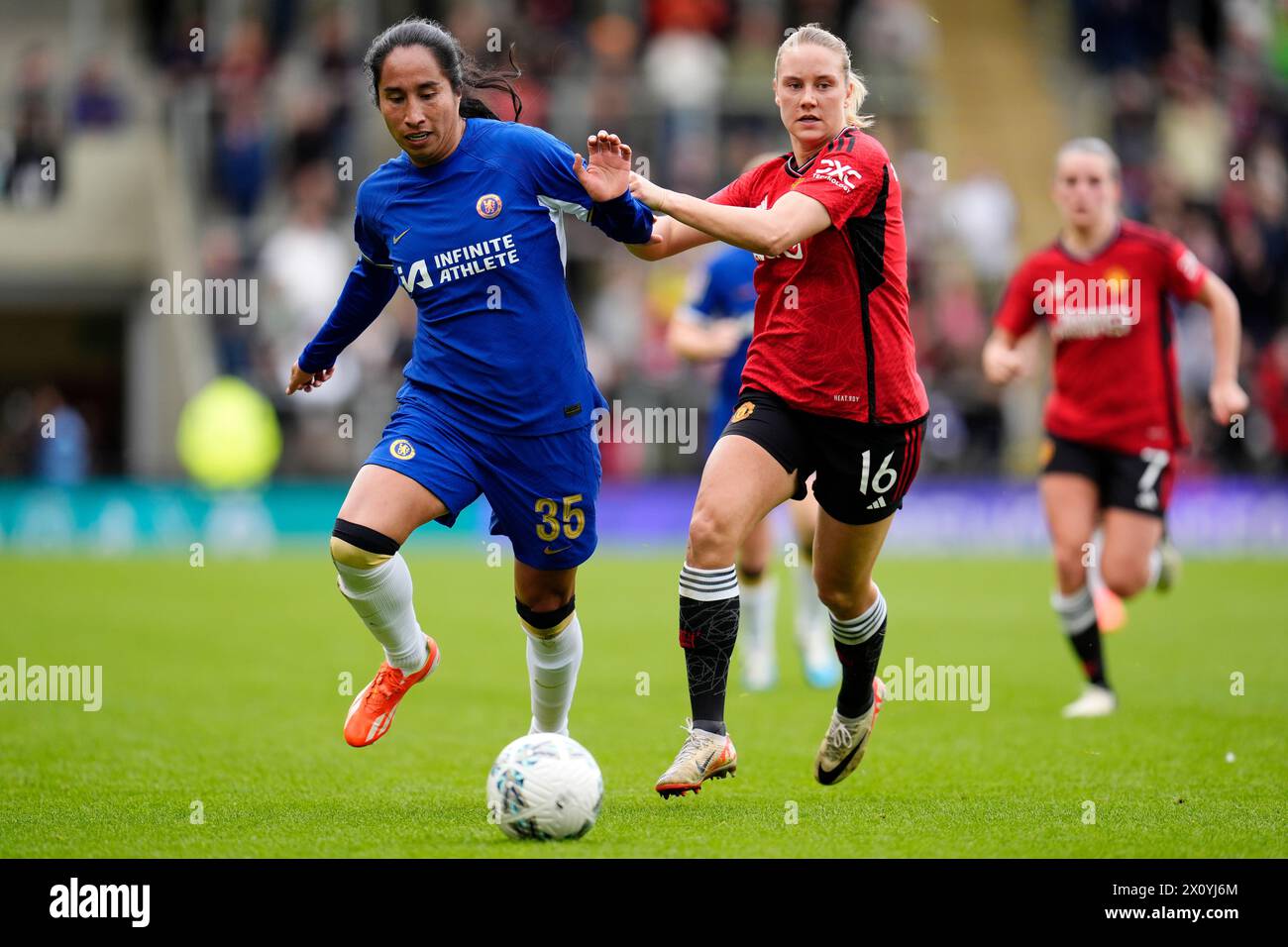 Chelsea's Mayra Ramirez (left) and Manchester United's Lisa Naalsund battle for the ball during the Adobe Women's FA Cup semi-final match at Leigh Sports Village. Picture date: Sunday April 14, 2024. Stock Photo