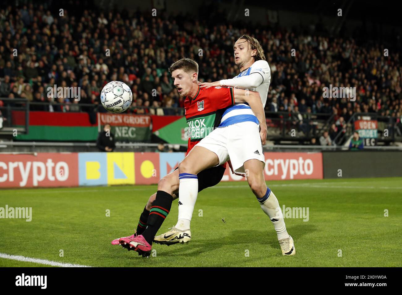 NIJMEGEN - (l-r) Mees Hoedemakers of NEC Nijmegen, Odysseus Velanas of PEC Zwolle during the Dutch Eredivisie match between NEC Nijmegen and PEC Zwolle in De Goffert on April 14, 2024 in Nijmegen, Netherlands. ANP BART STOUTJESDIJK Stock Photo