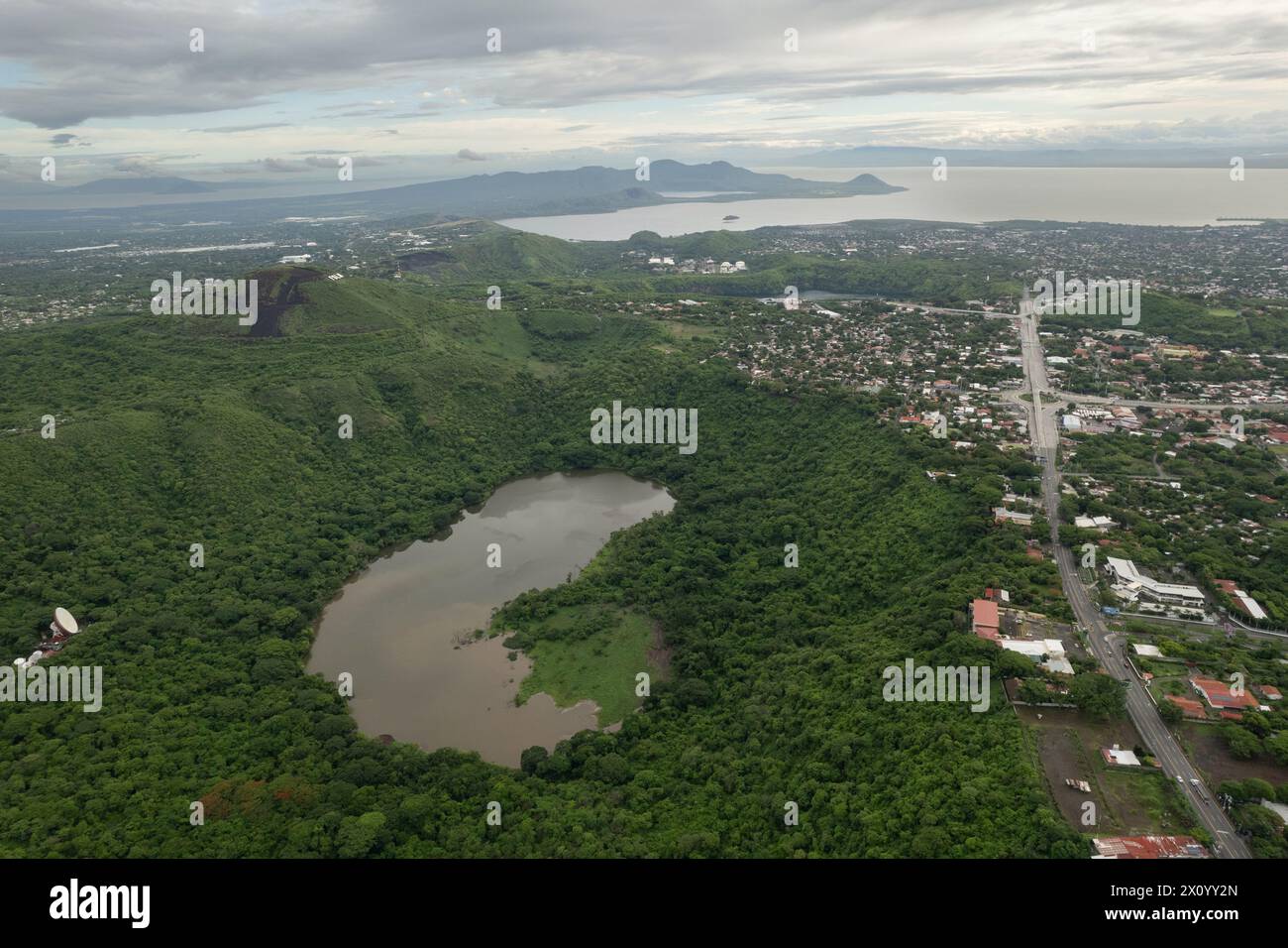 Green volcano crater next to Managua city in Central america aerial drone view Stock Photo