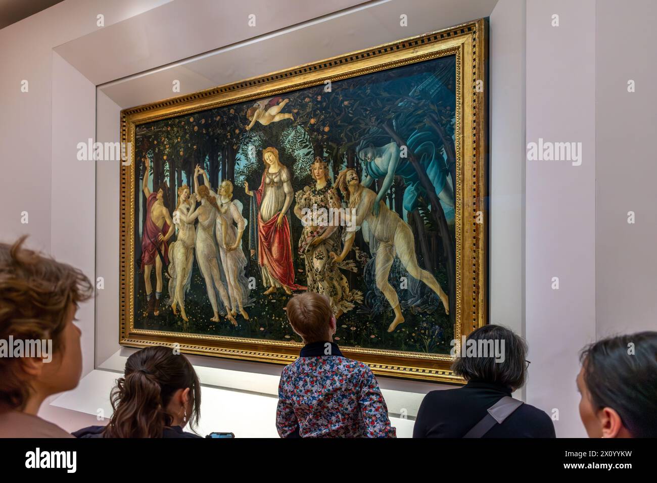 Florence, Italy - April 04, 2024: Visitors to the Uffizi Gallery Museum in Florence contemplate the famous painting The Spring by Sandro Botticelli (1 Stock Photo