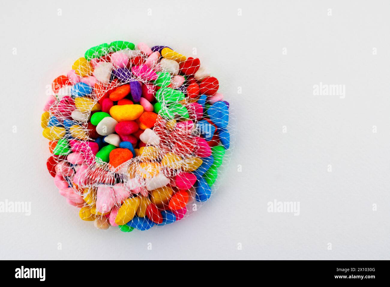 Mesh containing colorful decorative stones Stock Photo