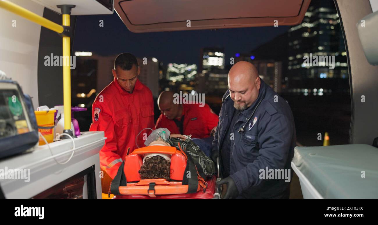 Ambulance, first aid and accident with a paramedic team on scene to rescue a person at night. Healthcare, medical and emergency with emt services on Stock Photo