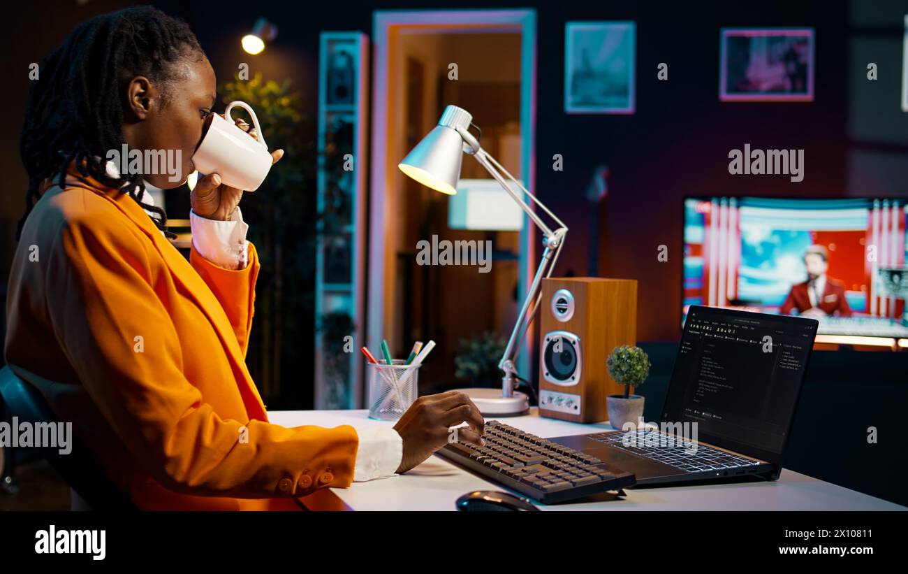 African american IT student practicing coding or programming exercises, learning hardware language and system debugging. Young woman studying database script on html window. Camera B. Stock Photo