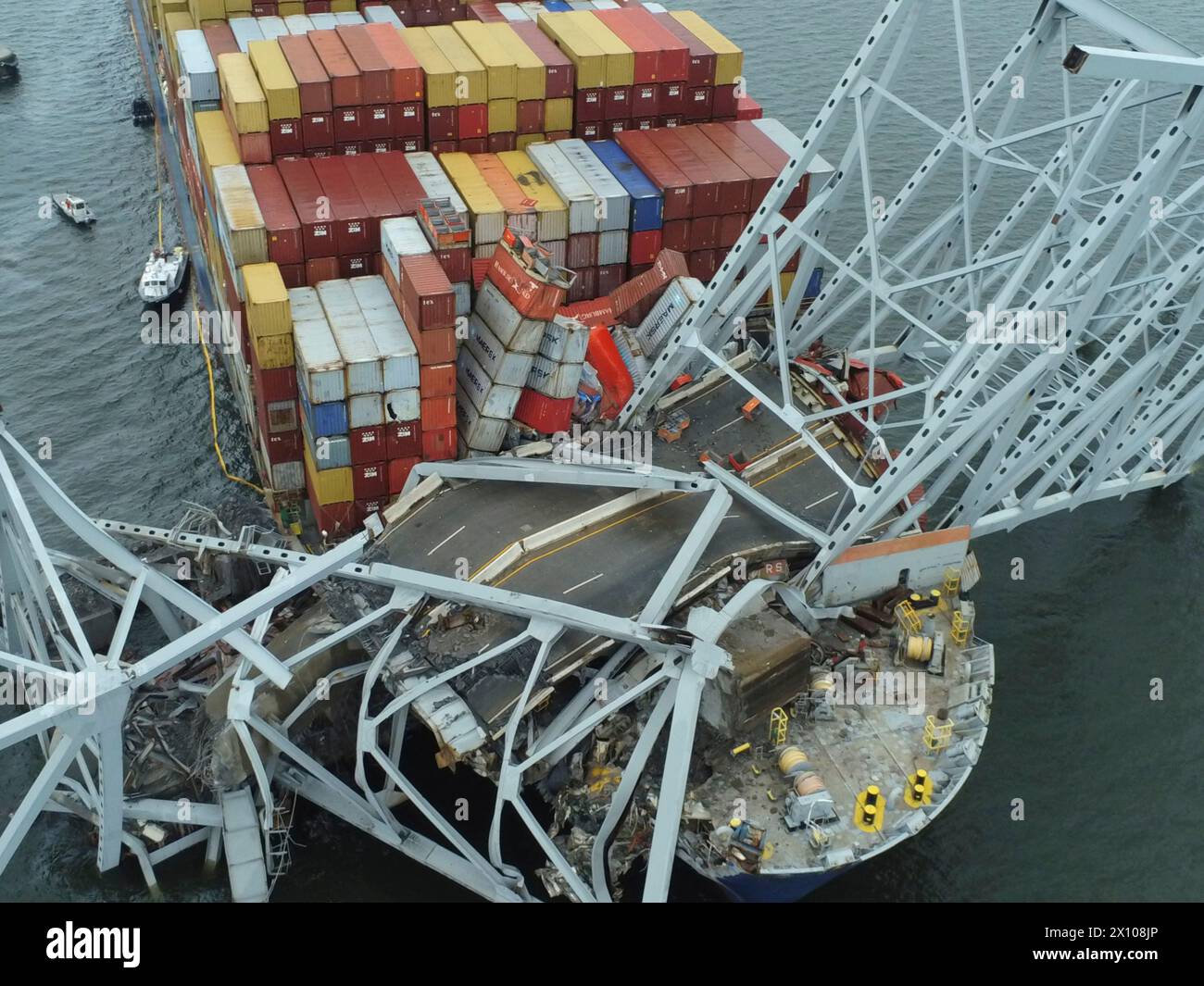 Dundalk, United States of America. 28 March, 2024. Aerial view of the entangled cargo carrier MV Dali encased in the steel trusses of the collapsed Francis Scott Key Bridge blocking the Fort McHenry channel, March 28, 2024, near Dundalk, Maryland. The bridge was struck by the 984-foot container ship on March 26th and collapsed killing six workers. Credit: PO3 Kimberly Reaves/US Coast Guard/Alamy Live News Stock Photo