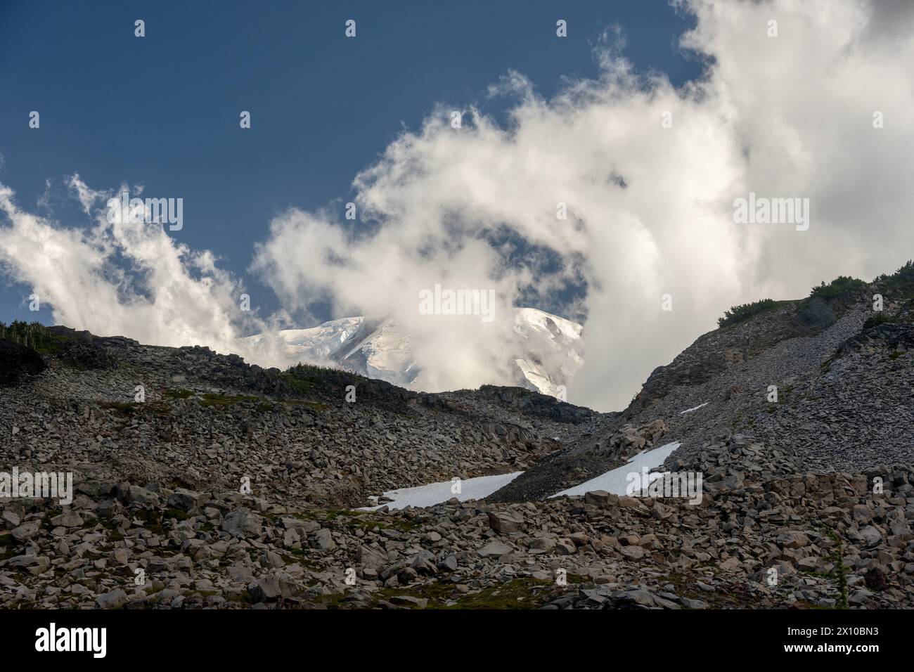 Looking Up To A Cloudy Mount Rainier From Spray Park on summer afternoon Stock Photo