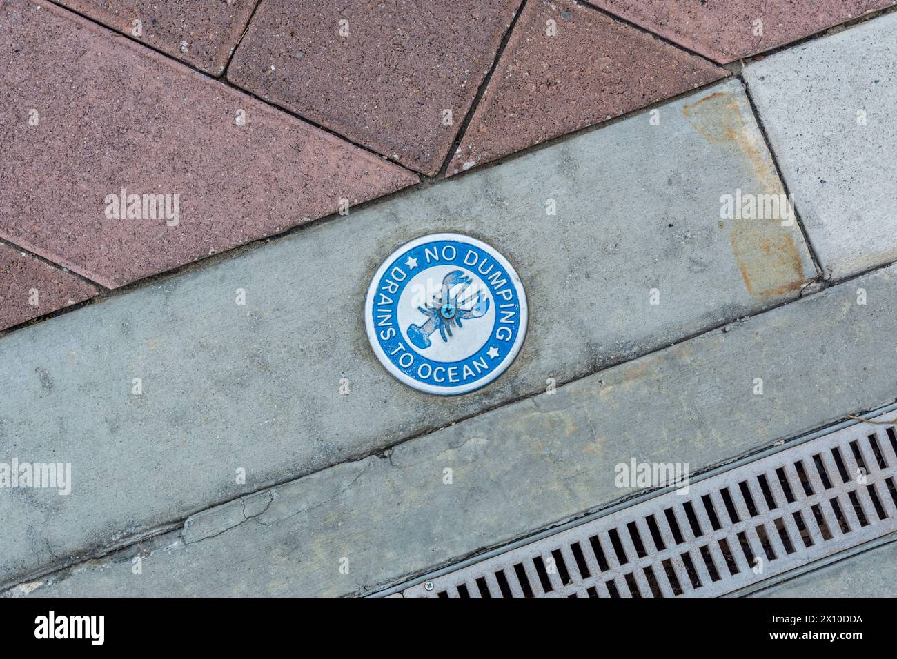 A sign in Los Angeles warns that improper disposal into the storm drain can pollute the ocean Stock Photo