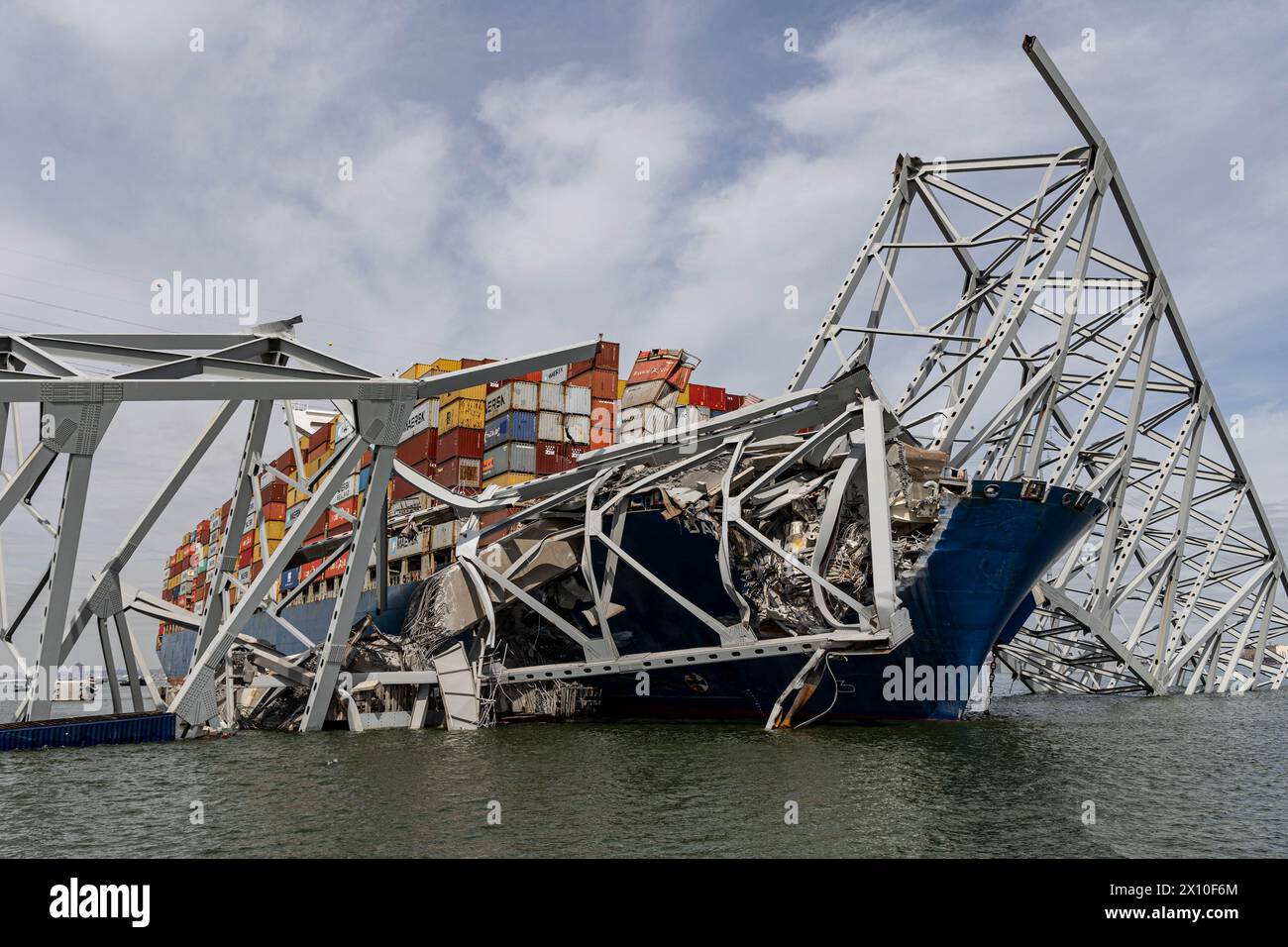 Dundalk, United States of America. 26 March, 2024. The entangled cargo carrier MV Dali encased in the steel trusses of the collapsed Francis Scott Key Bridge blocking the Fort McHenry channel, March 26, 2024, near Dundalk, Maryland. The bridge was struck by the 984-foot container ship in the early morning on March 26th and collapsed killing six workers and shutting the Port of Baltimore. Credit: Dave Adams/USACE/Alamy Live News Stock Photo
