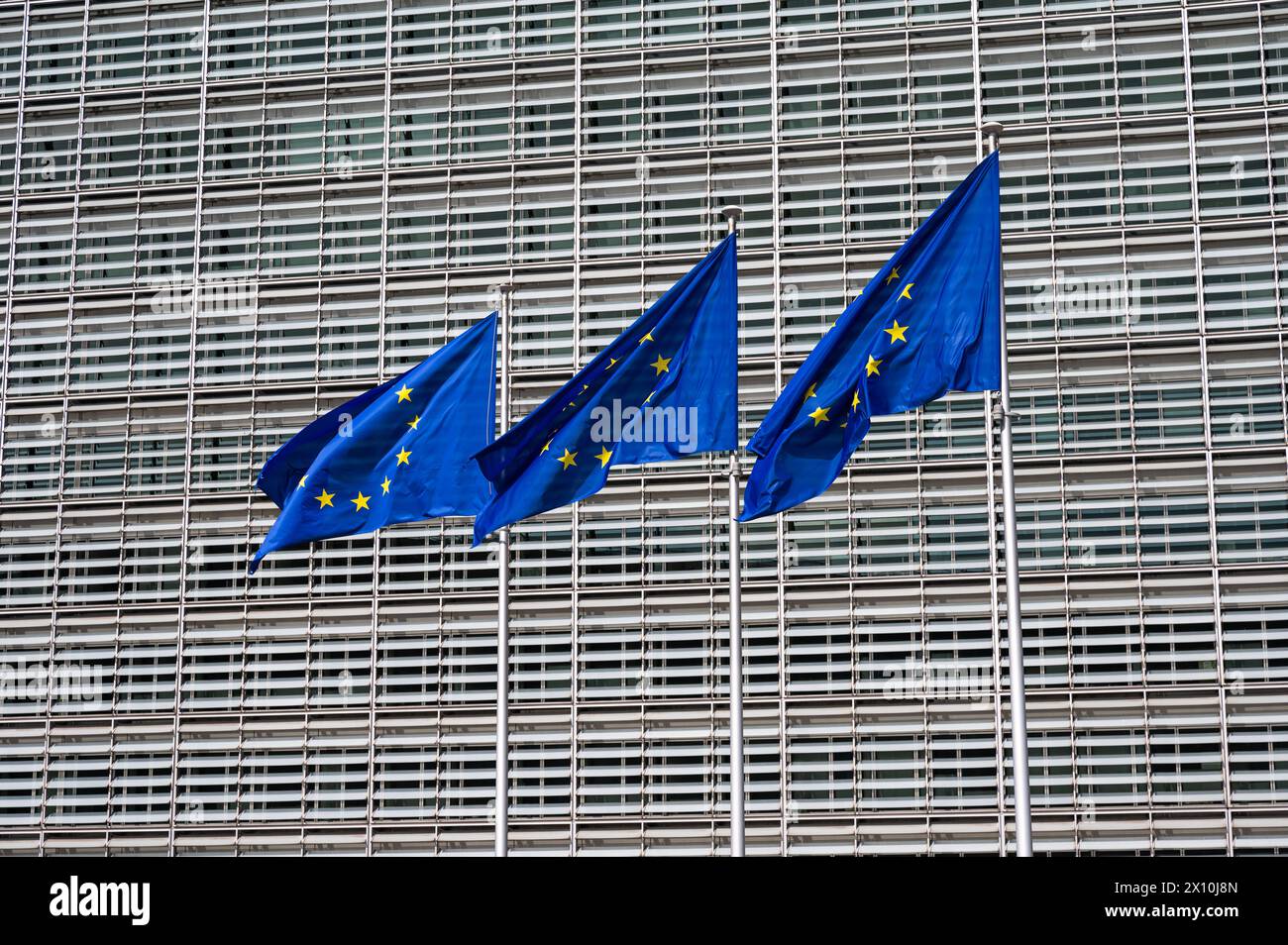 Etterbeek, Brussels, Belgium - April 13, 2024 - Three flags of the European union at the Berlaymont building of the European Commission Stock Photo