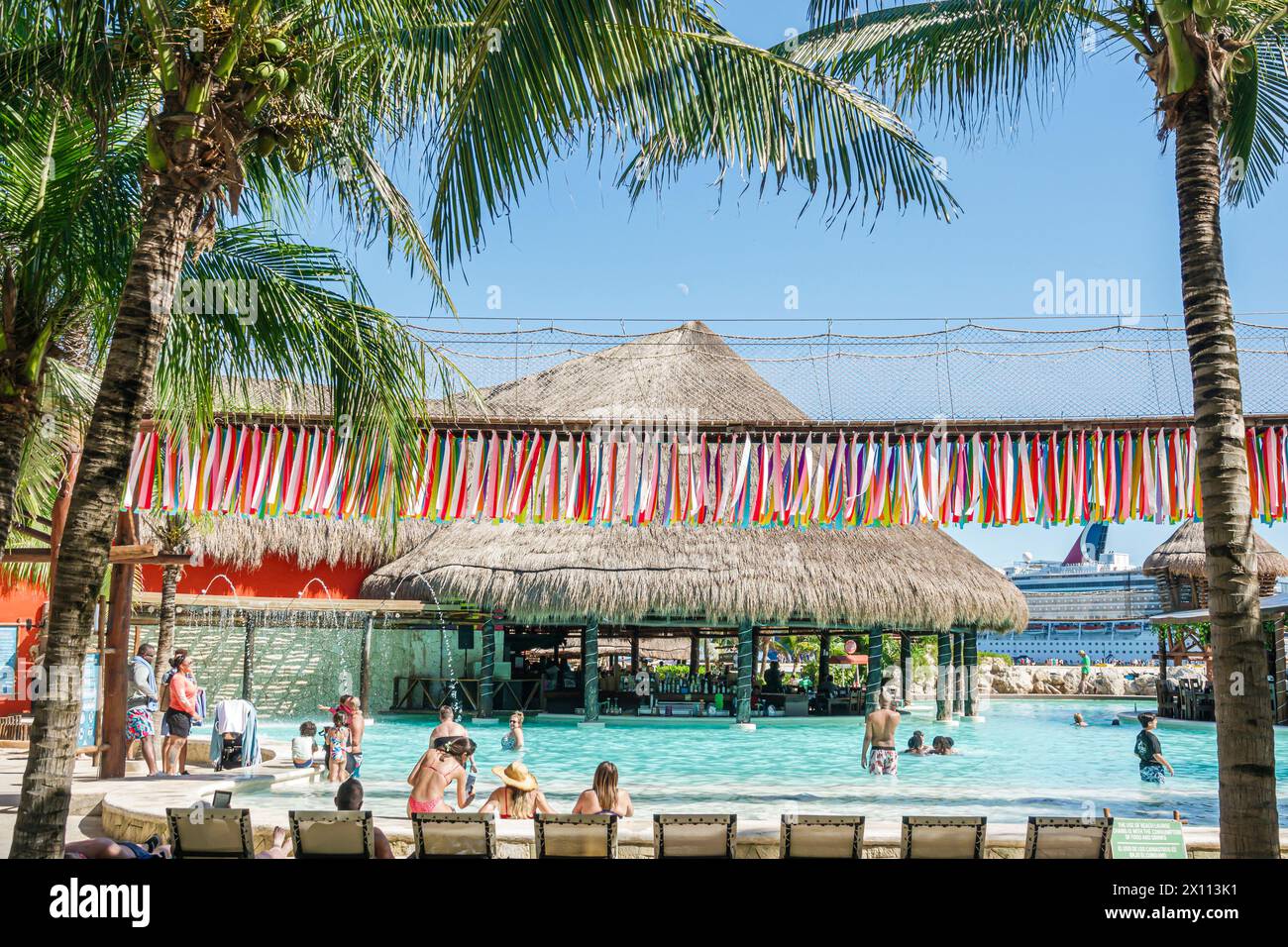 Costa Maya Mexico,Cruise Port,Norwegian Joy Cruise Line ship,7-day Caribbean Sea itinerary,swimming pool,floating bar,palapa thatched roof dried palm Stock Photo
