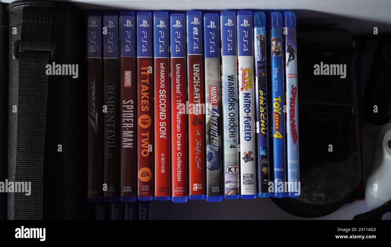 Playstation 4 physical game and blu-ray disks arranged in a drawer Stock Photo