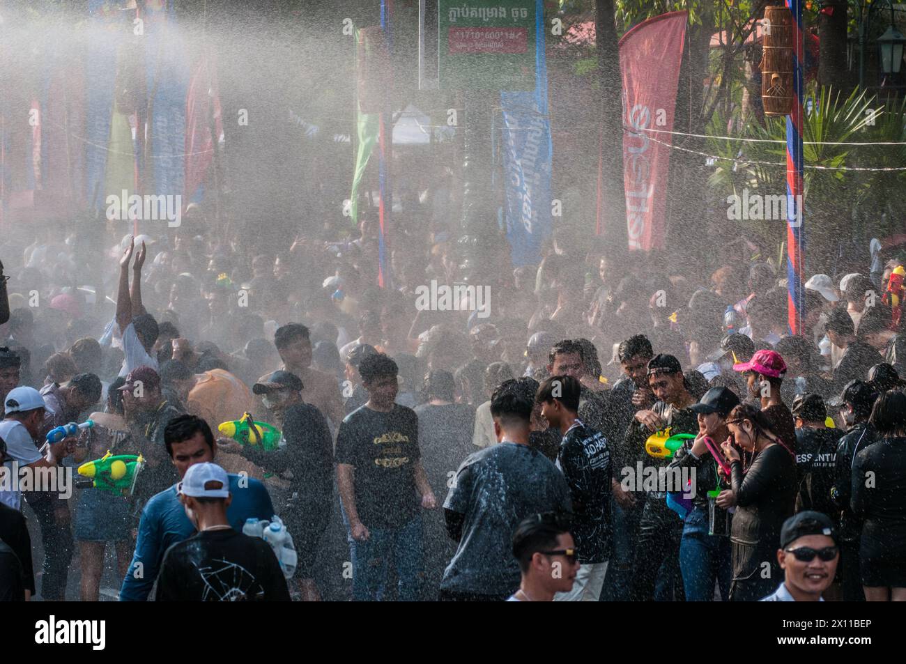 Water is sprayed onto a densely packed crowd during The Cambodian New