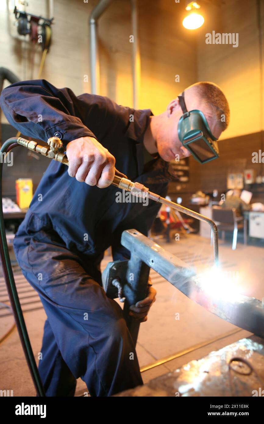 Lance Cpl. Skyler L. Soares, a welder with Support Company, 7th Engineer Support Battalion, 1st Marine Logistics Group, heats up a Logistics Vehicle System mud flap frame at Camp Pendleton, Calif., Jan. 7, 2010. Stock Photo