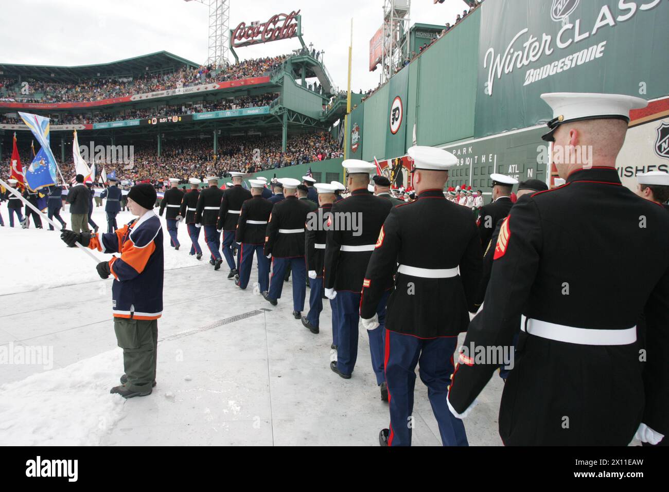 Marine Corps, Air Force, Navy, Coast Guard and Army service members stand in formation on Fenway Park for a pre-game ceremony before the 2010 Bridgestone NHL Winter Classic, Jan. 1, 2010. The Air Force provided a B-2 fly over to culminate the pre-game event. Stock Photo