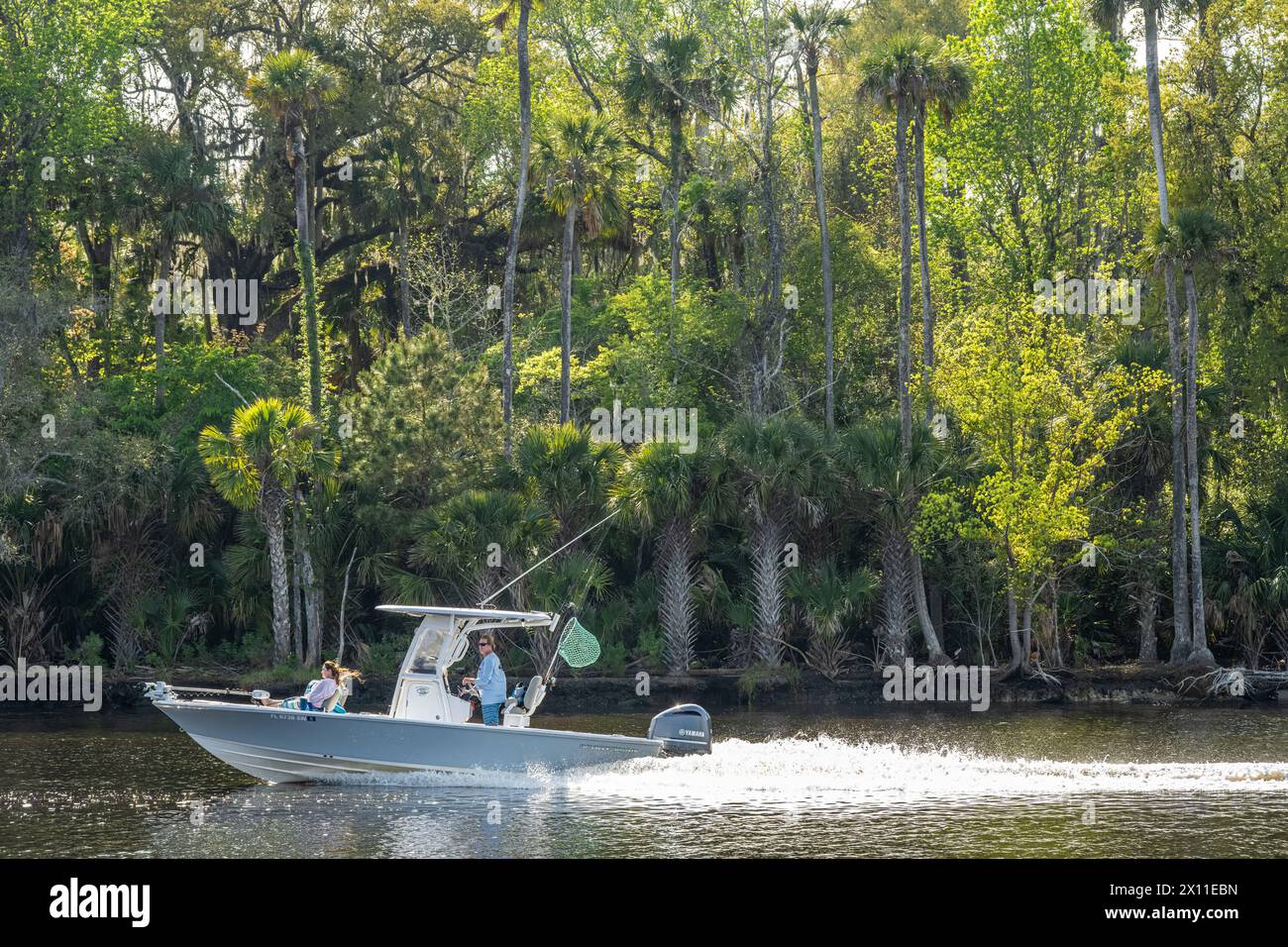 Couple cruising the Intracoastal Waterway in a Sportsman fishing boat between Palm Valley and Nocatee in Northeast Florida. (USA) Stock Photo