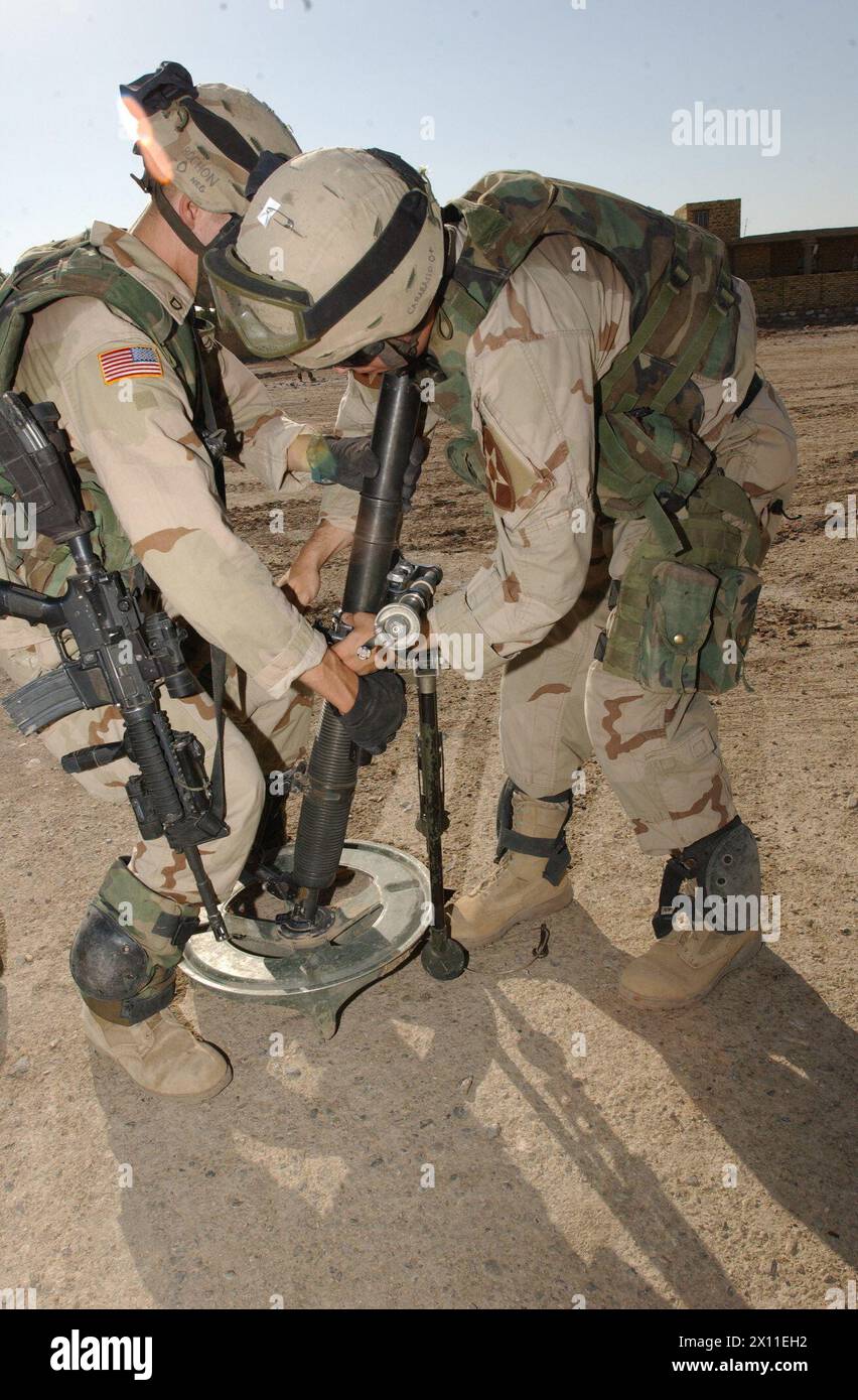 Soldiers from the 1st Battalion, 23rd Infantry Regiment, 3rd Brigade, 2nd Infantry Division (Stryker Brigade Combat Team) set up an indirect firing position in Al Dujaya, an Iraqi town south of Al Kut on Aug. 19, 2004. Stock Photo