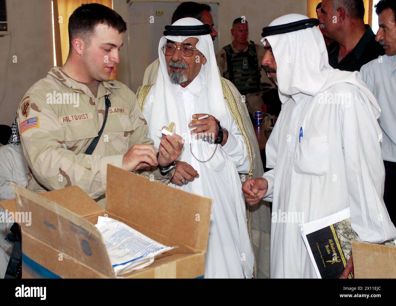 Sgt John Hultquist, civil affairs sgt., 489th CA Battalion, 2-7 Cav, 39th BCT, 1st CD shows members of the AL-Taji Nahia some of the medical supplies Hultquist's team delivered. In addition to medical equipment, the CA team delivered school supplies ca. September 05, 2004 Stock Photo