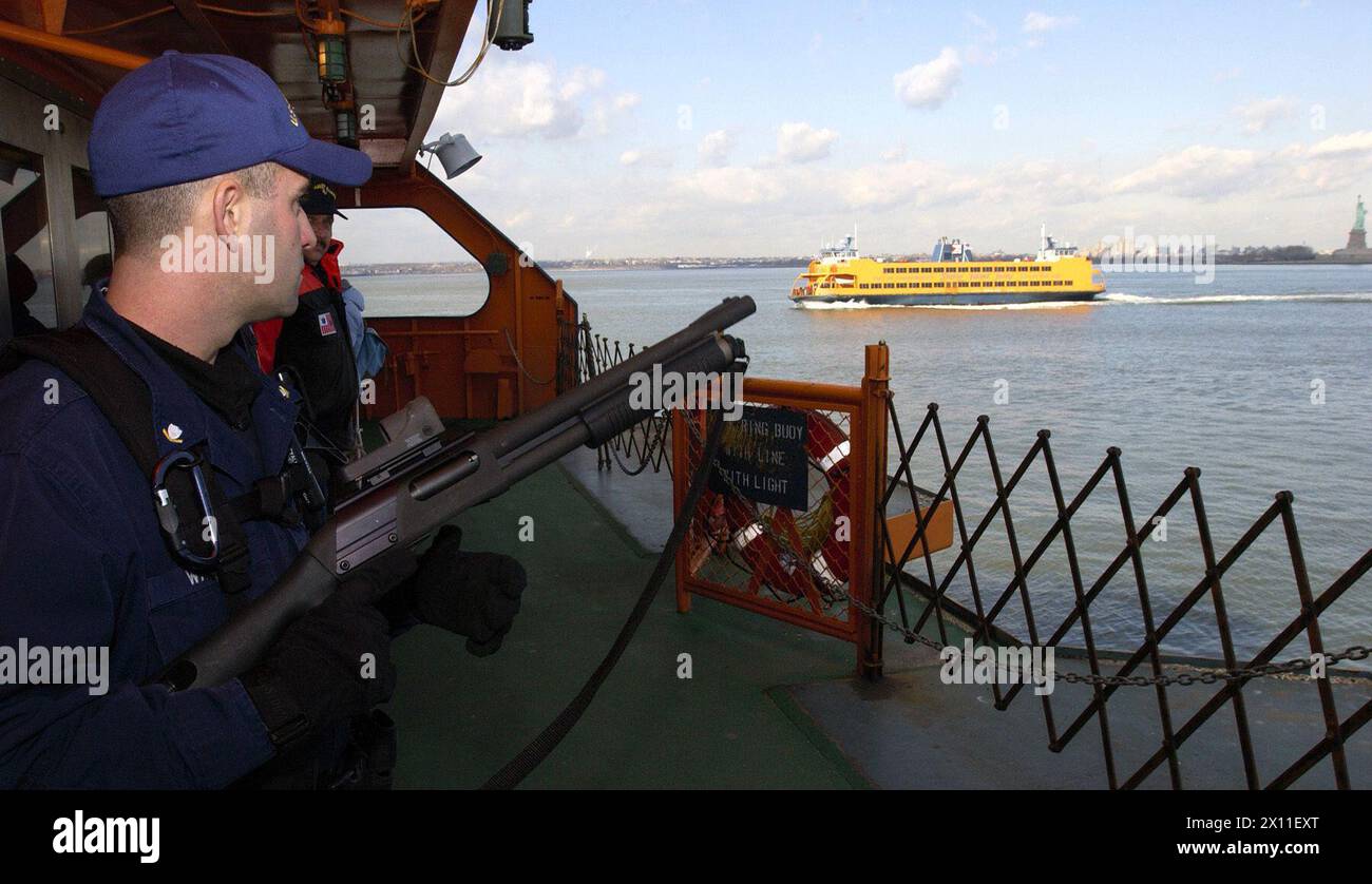 NEW YORK, New York (Jan. 8, 2004)--Petty Officer 3rd Class Chad Walder of Franklin Lakes, N.J., patrols a Staten Island Ferry with members of a commercial vessel boarding team January 8, 2004 in New York harbor. Stock Photo
