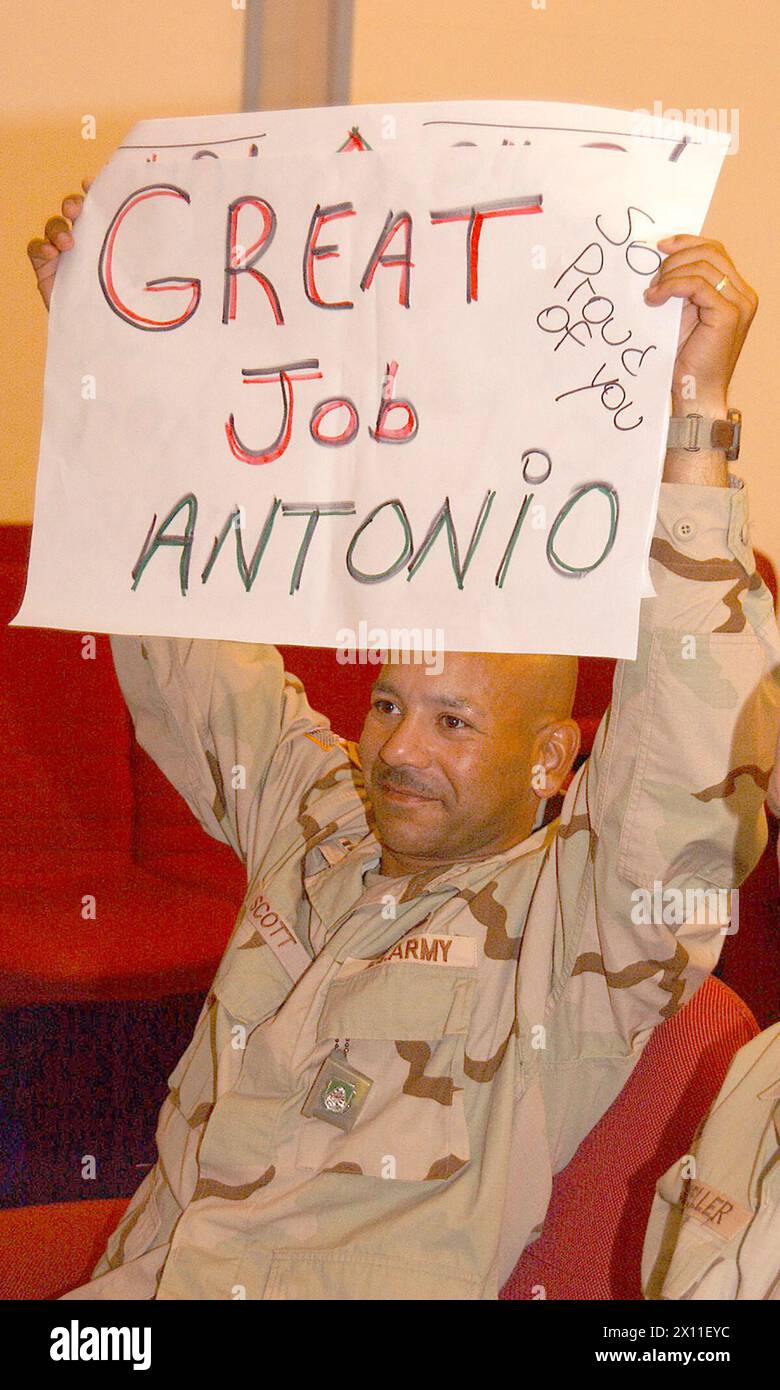 Chief Warrant Officer William Scott, battalion maintenance officer assigned to Headquarters and Headquarters Company, 123rd Main Support Battalion, cheers on his son, Antonio, from Freedom Rest in Baghdad, Iraq. Scott was able to watch Antonio on a Video Teleconference system as he graduated from General H.H. Arnold High School in Wiesbaden, Germany June 5 2004. Stock Photo