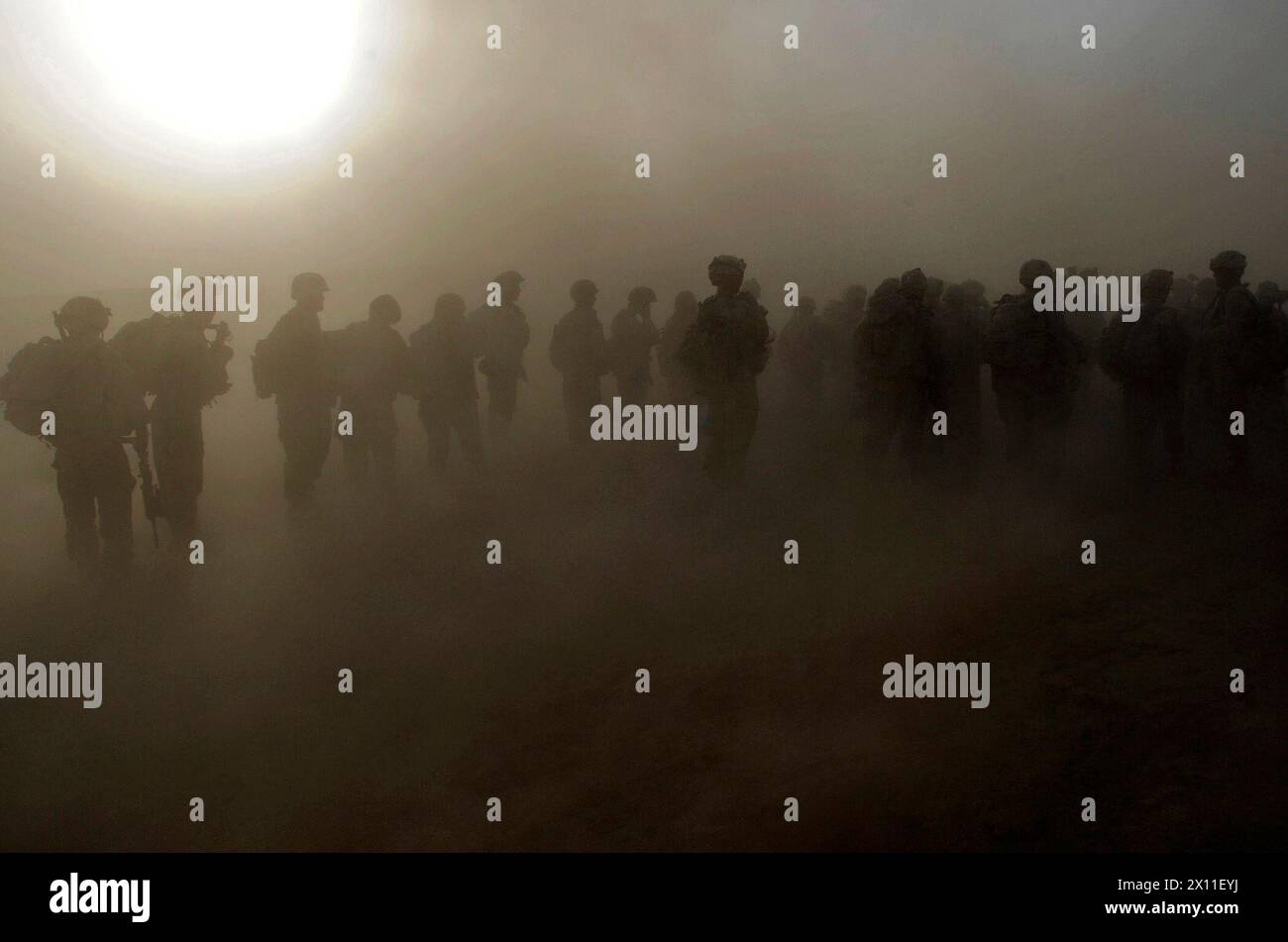 Paratroopers from the 1st Platoon, Company C, 1st Battalion, 501st Infantry Regiment, 4th Brigade Combat Team, 25th Infantry Division, wait in a dust storm for the beginning of an air assault mission at Forward Operating Base Kushamond, Afghanistan ca. September 07, 2004 (metadata lists year as 2009) Stock Photo